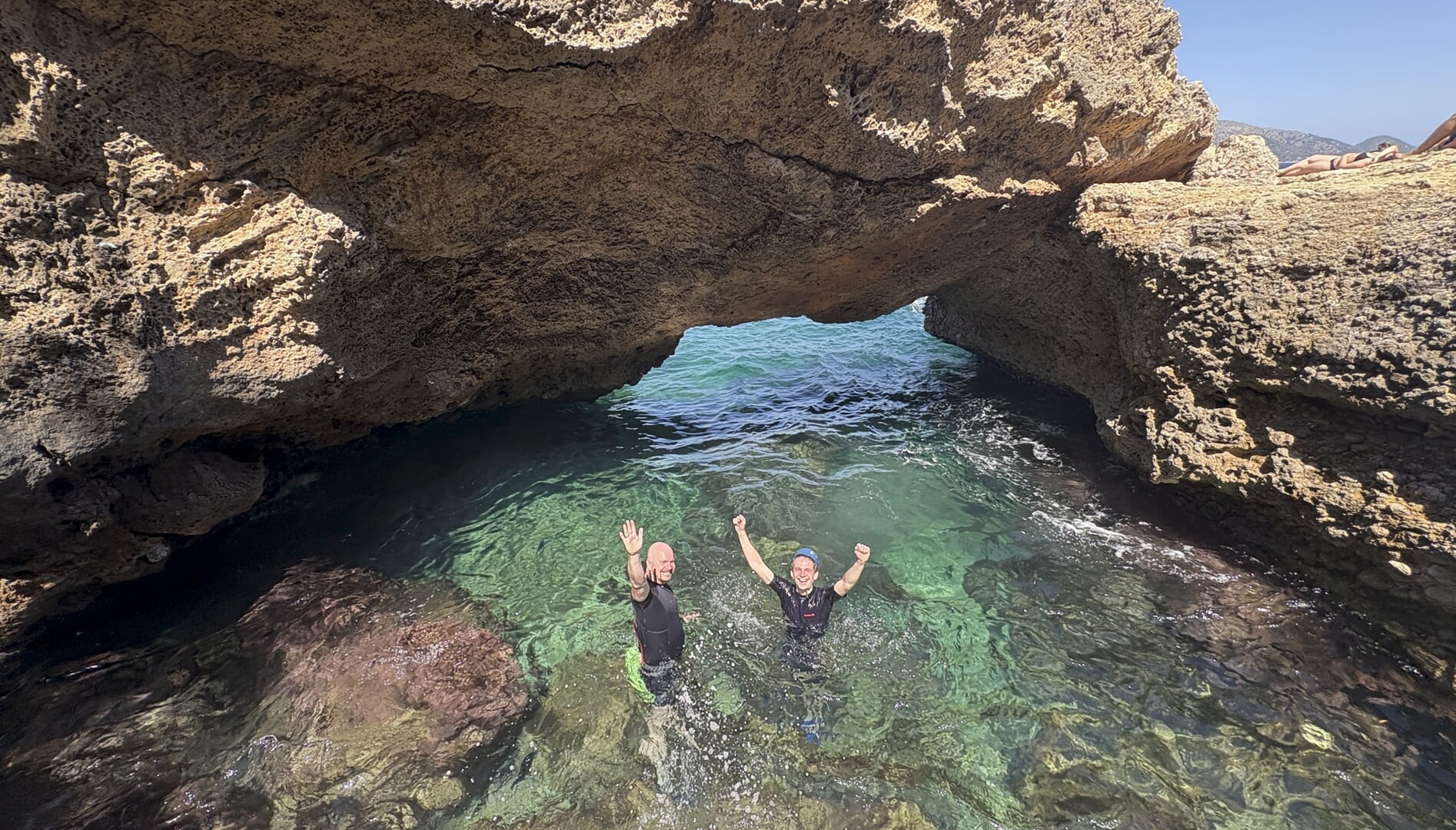 Swimming between coastal sections during coasteering in Alcudia