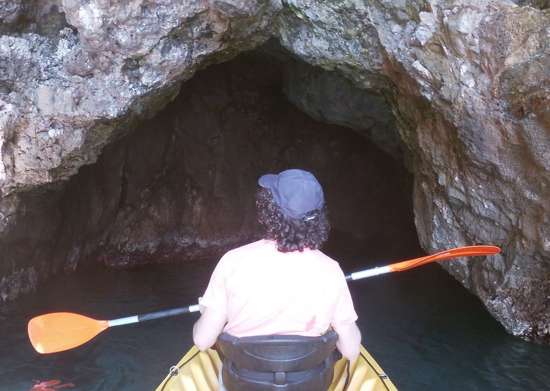 Entering a cave on the Kayak Tour